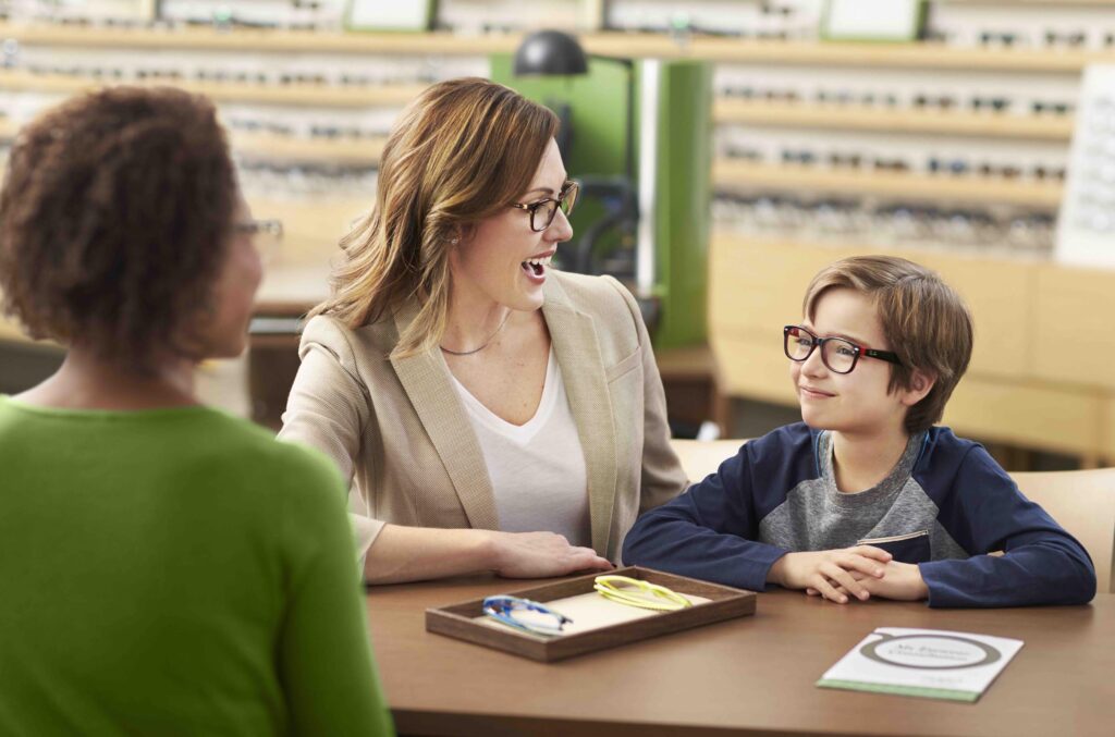 A young patient and his mother are fitted for glasses at a Pearle Vision EyeCare Center.