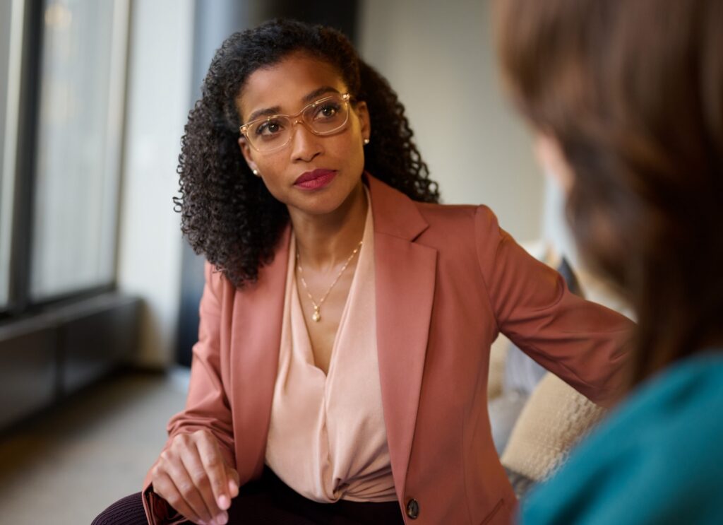 Two business women having a casual conversation.