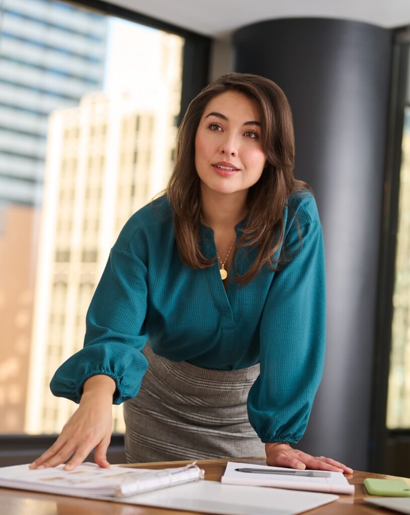 Woman going over paperwork in a corporate setting.